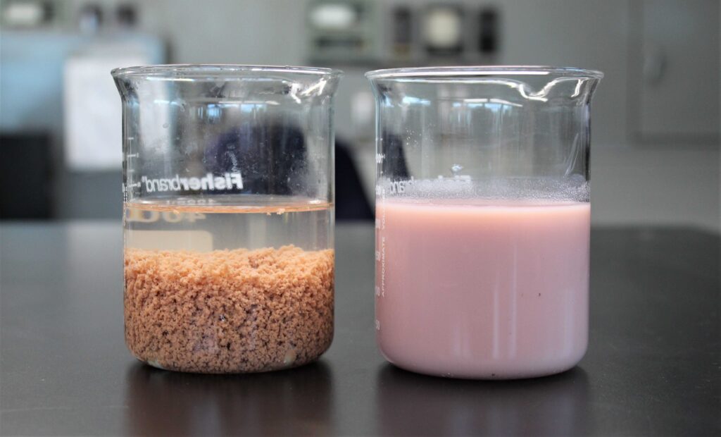 Beakers depicting stages in wastewater treatment 
