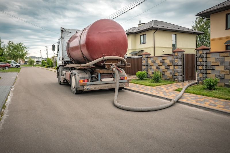 Sewage Tank truck. Sewer pumping machine. Red Septic truck. Industrial theme